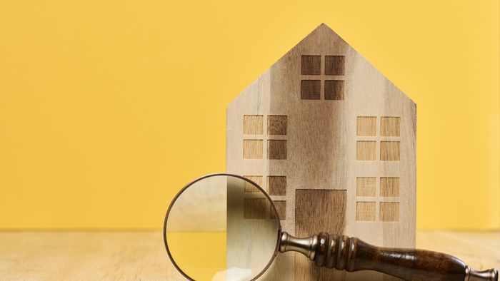 magnifying glass in front of a house
